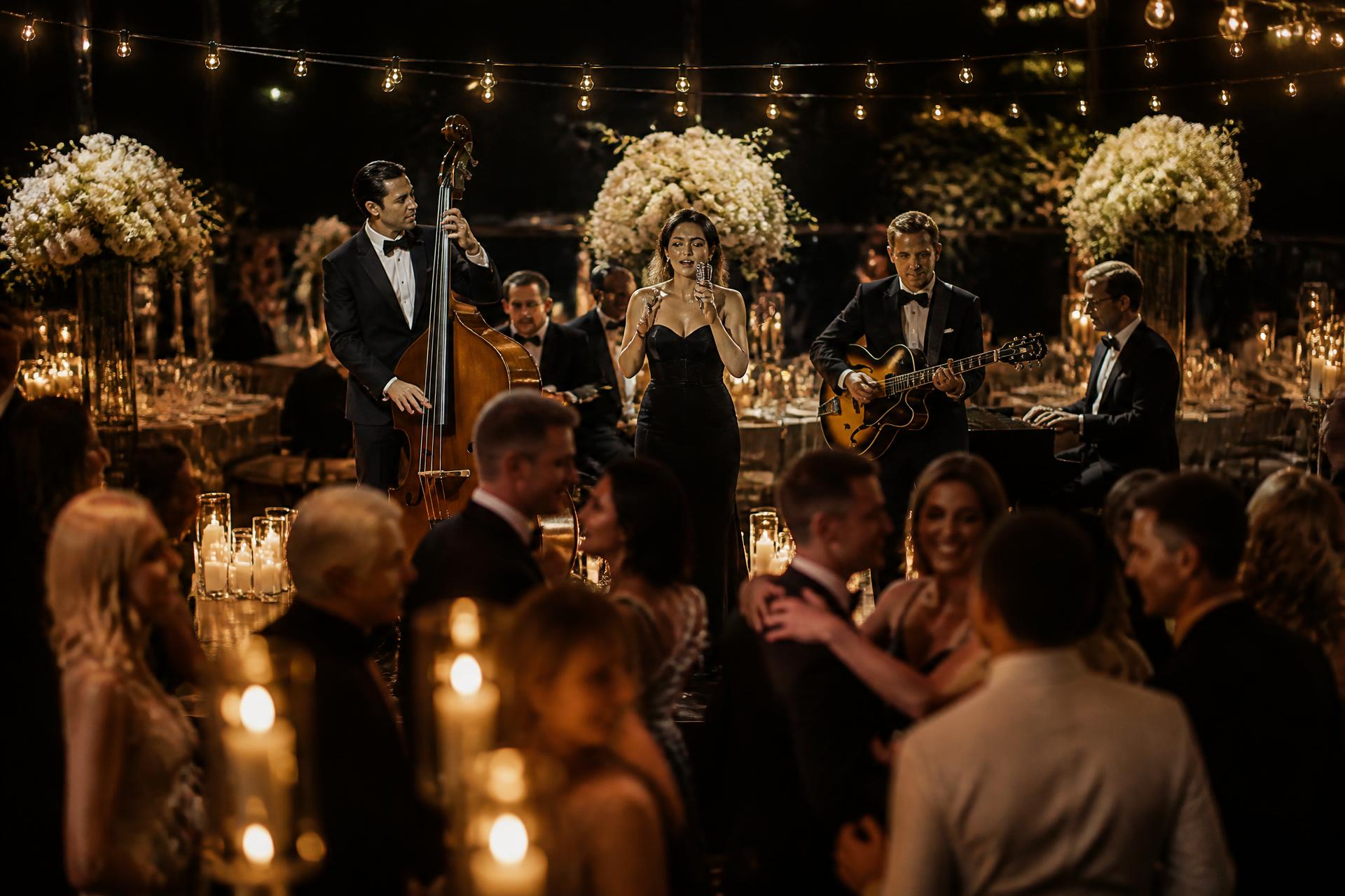Elegant live wedding band performing at a candlelit luxury reception